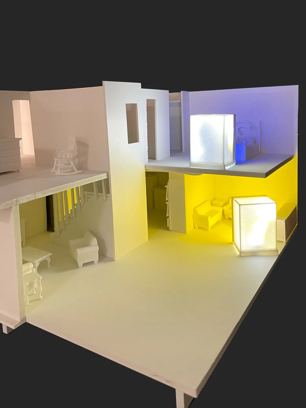 Detail view of miniature domestic sculpture with warm and cool lighting